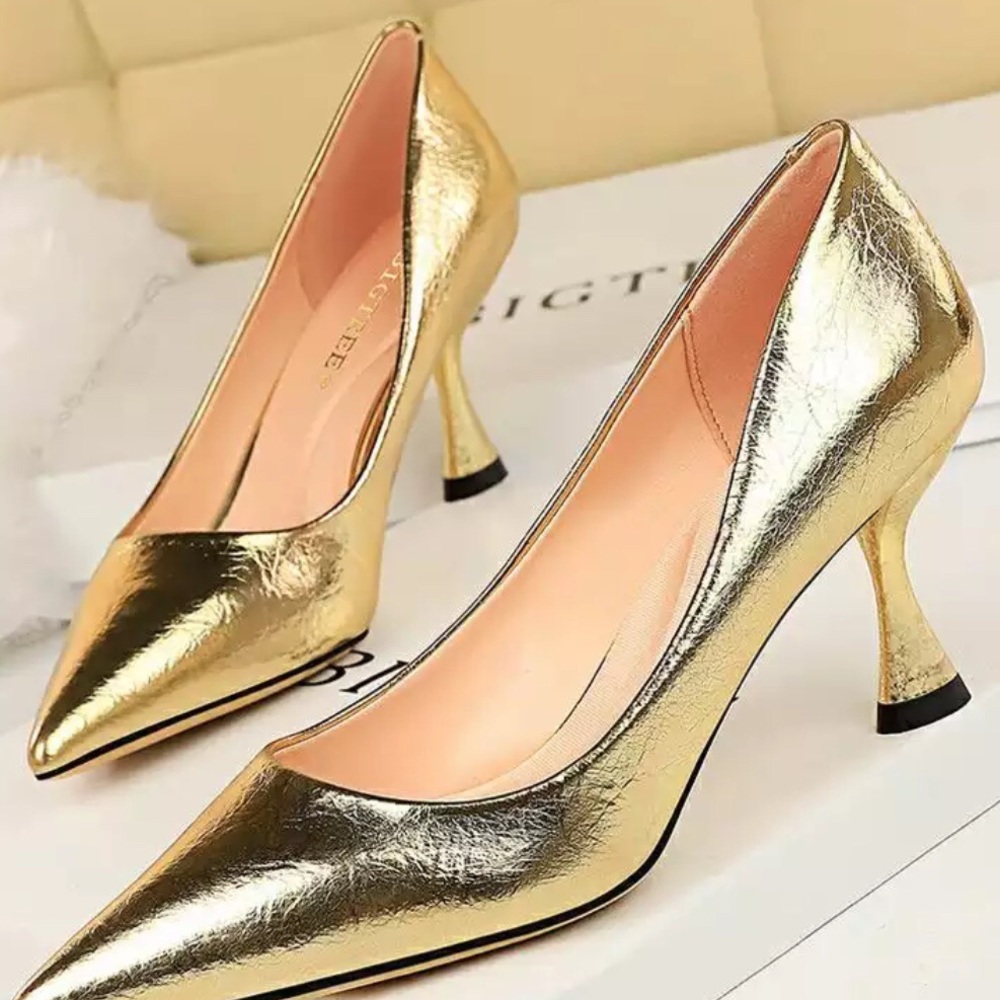 Gold leather- like pointed toe pump.